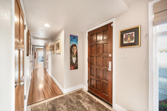 entryway featuring a textured ceiling