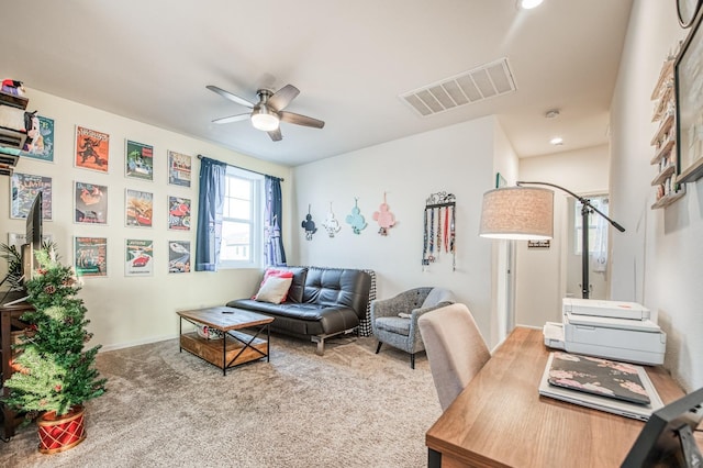 carpeted living room featuring a ceiling fan and visible vents