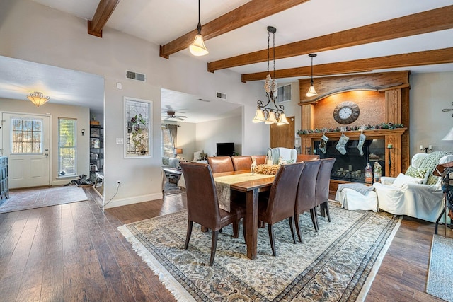 dining room with beam ceiling, ceiling fan with notable chandelier, and dark wood-type flooring