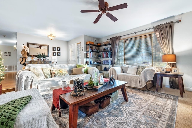 living room with ceiling fan and carpet floors