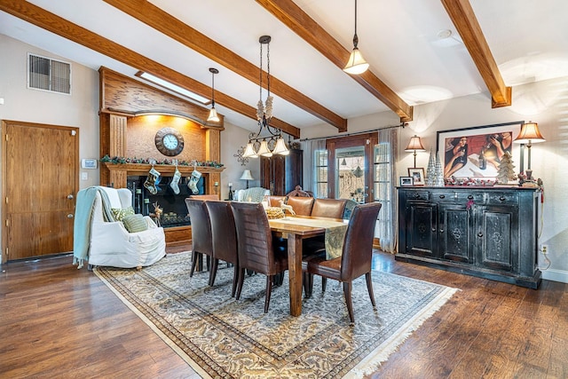 dining space with lofted ceiling with beams and dark wood-type flooring