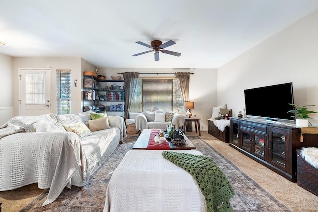 carpeted living room with ceiling fan