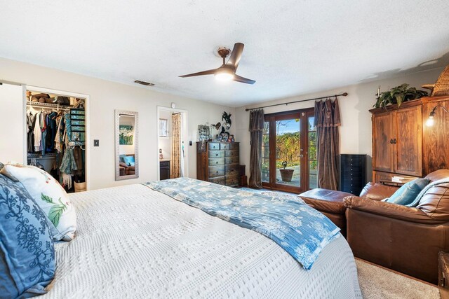 carpeted bedroom with access to outside, ceiling fan, a closet, and a textured ceiling