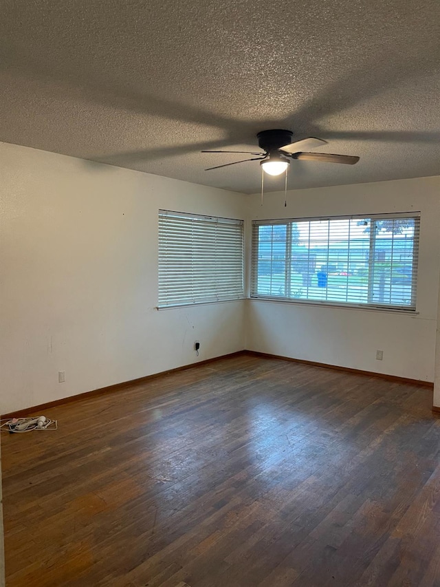 spare room featuring a textured ceiling, dark hardwood / wood-style floors, and ceiling fan