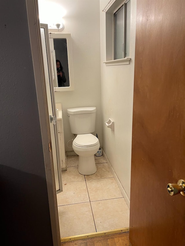 bathroom with tile patterned flooring and toilet