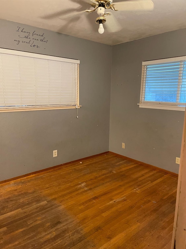 empty room featuring ceiling fan and hardwood / wood-style floors