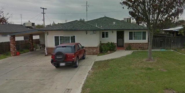 single story home with a front yard and a carport