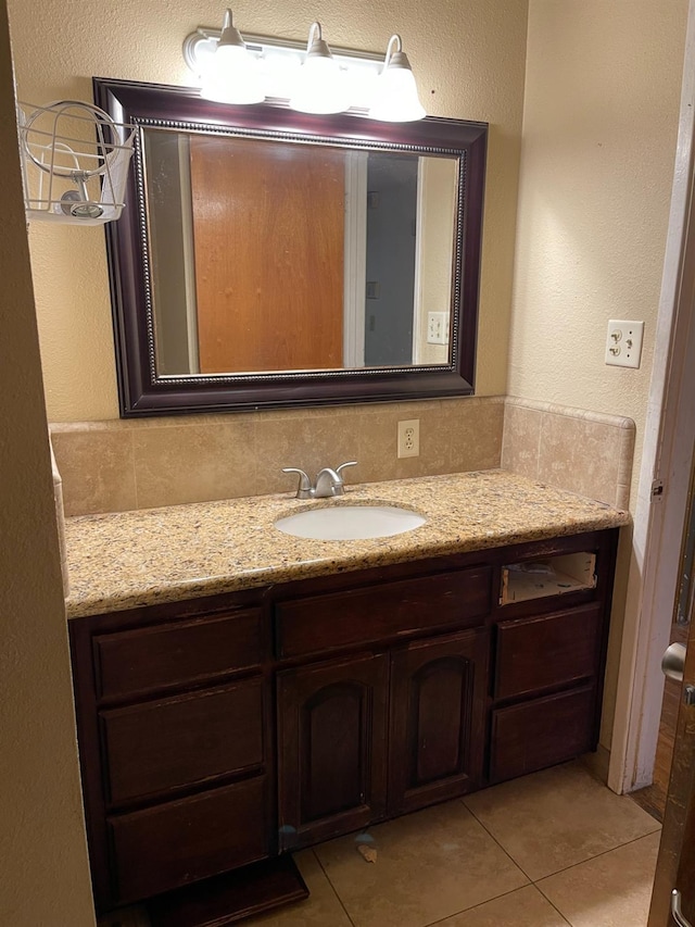 bathroom with vanity, tasteful backsplash, and tile patterned floors