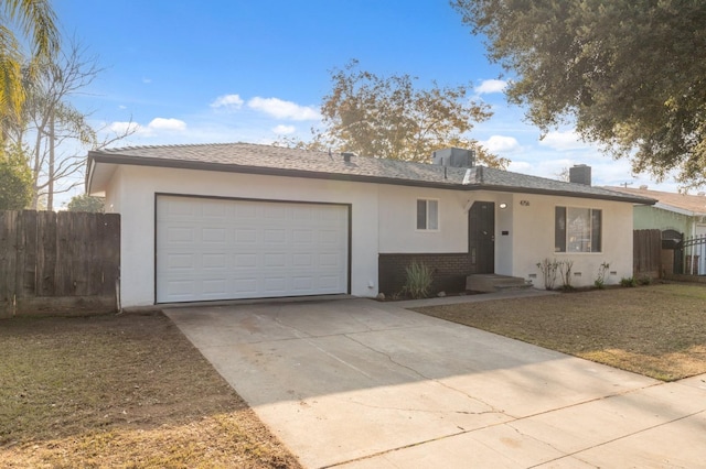 ranch-style house featuring stucco siding, an attached garage, concrete driveway, and fence