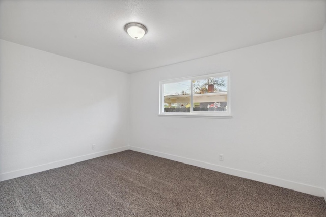 4756 E Woodward Ave, Fresno, CA 93702 - spare room with baseboards and dark colored carpet