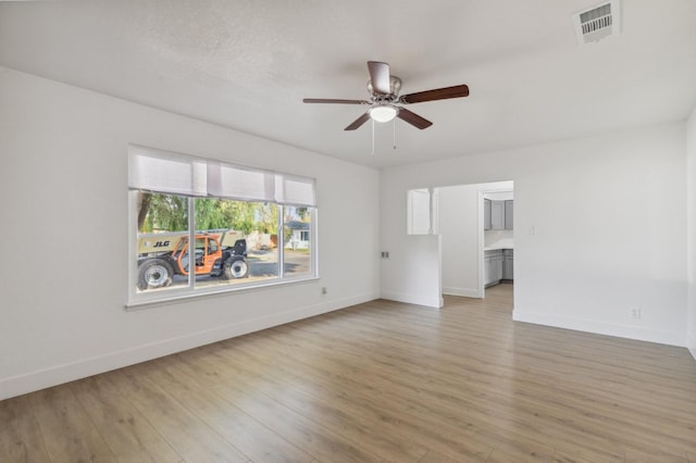 4756 E Woodward Ave, Fresno, CA 93702 - spare room with light wood-style floors, visible vents, baseboards, and a ceiling fan