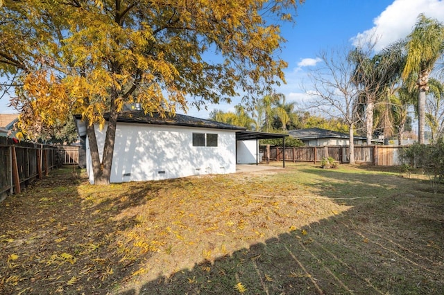 rear view of property featuring a lawn