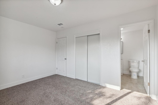 4756 E Woodward Ave, Fresno, CA 93702 - unfurnished bedroom featuring a closet, connected bathroom, visible vents, and carpet floors