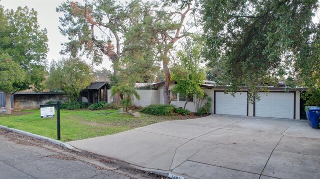 single story home with a garage and a front yard