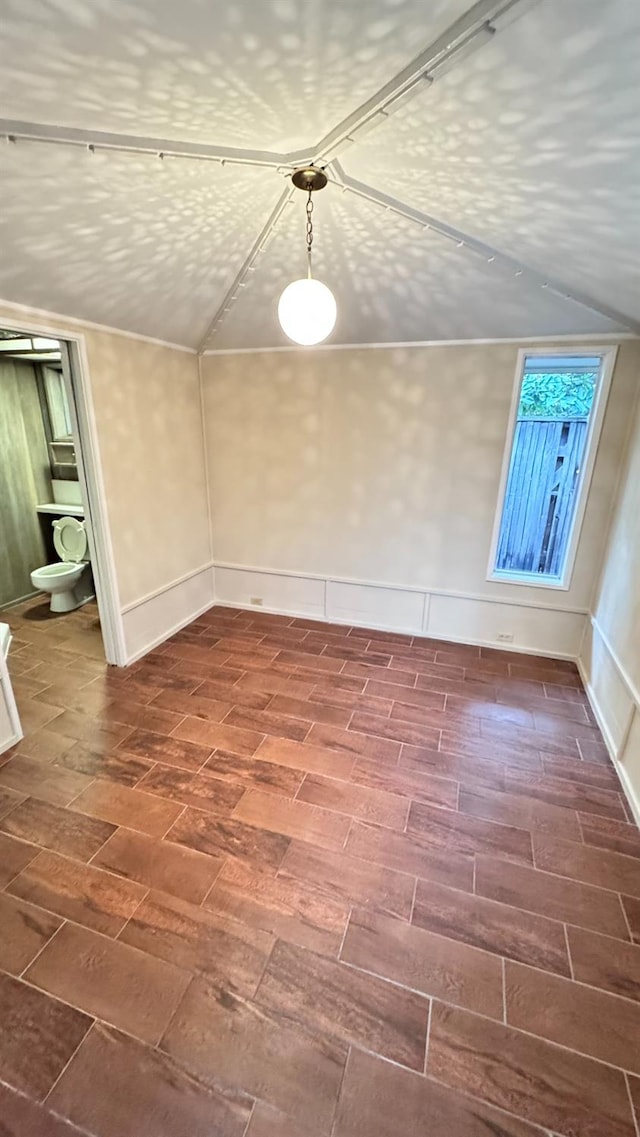 unfurnished dining area featuring vaulted ceiling and a textured ceiling