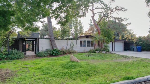 view of front facade with a front lawn and a garage