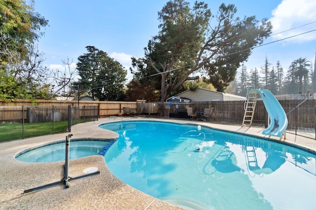 5870 E Midwick Ln, Fresno, CA 93727 - view of pool featuring a water slide, a fenced backyard, and a pool with connected hot tub