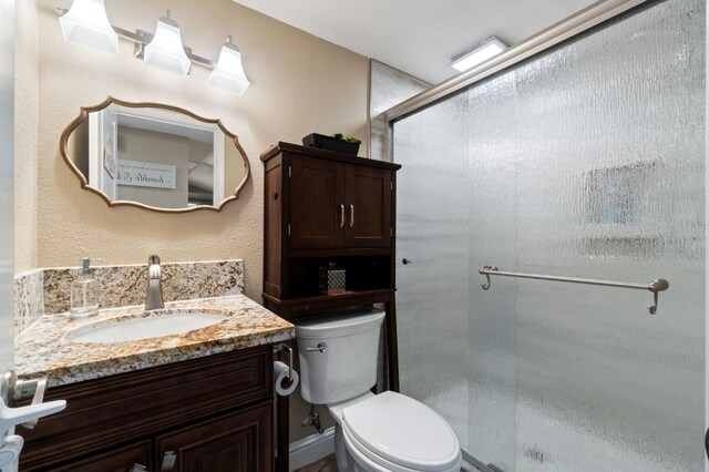 5870 E Midwick Ln, Fresno, CA 93727 - full bathroom featuring toilet, vanity, and a shower stall