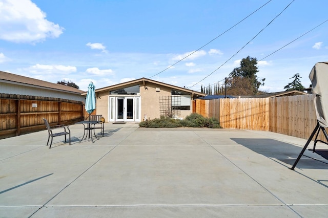 5870 E Midwick Ln, Fresno, CA 93727 - fenced backyard with french doors and a patio area