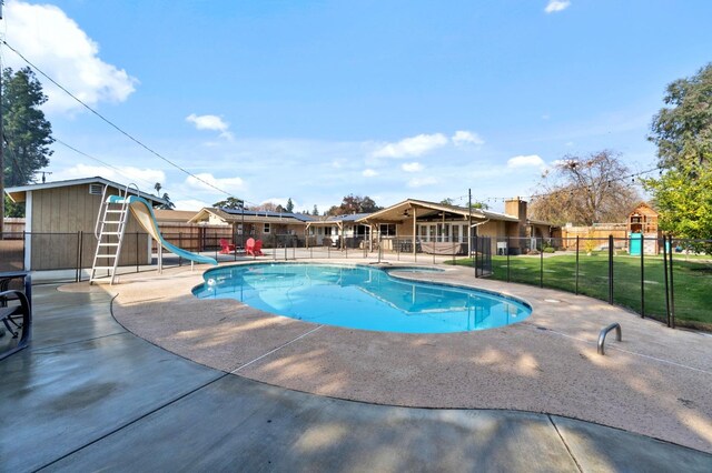 5870 E Midwick Ln, Fresno, CA 93727 - view of swimming pool featuring a water slide and a patio