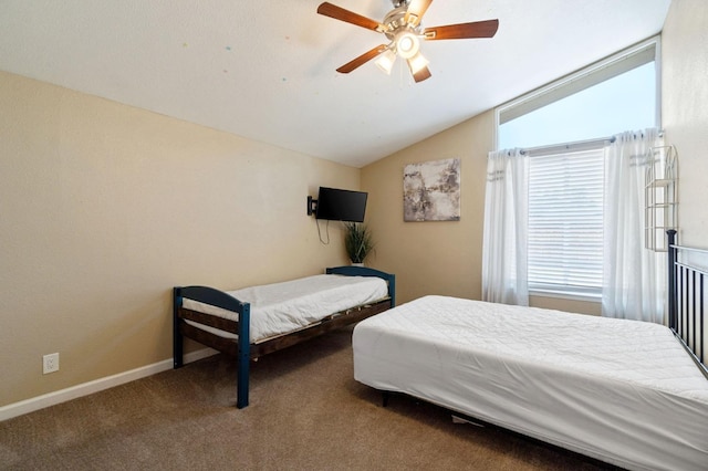 5870 E Midwick Ln, Fresno, CA 93727 - bedroom featuring multiple windows, vaulted ceiling, carpet, ceiling fan, and baseboards