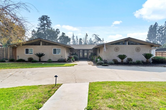 5870 E Midwick Ln, Fresno, CA 93727 - view of front facade featuring french doors, stucco siding, and curved driveway