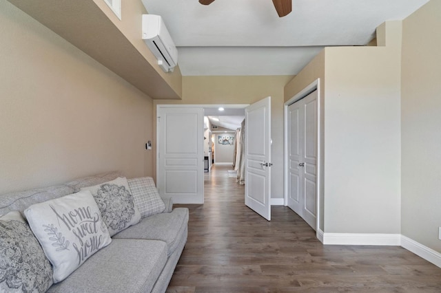 5870 E Midwick Ln, Fresno, CA 93727 - living area featuring an AC wall unit, baseboards, wood finished floors, and ceiling fan