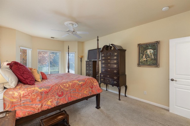 bedroom with ceiling fan and light carpet