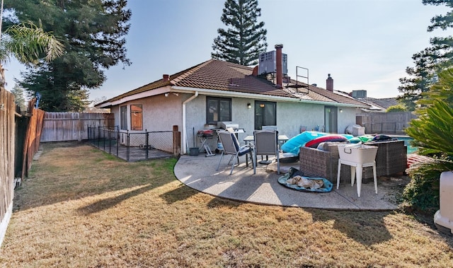 rear view of house featuring central AC, a lawn, and a patio area