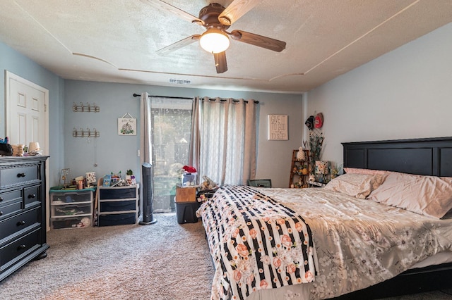 bedroom featuring ceiling fan, a textured ceiling, and carpet