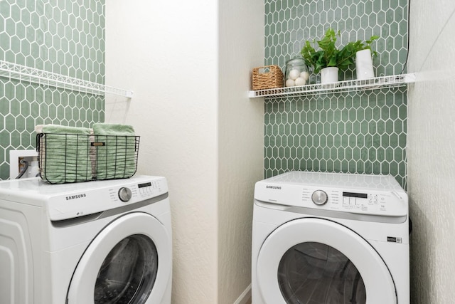 washroom with laundry area and washer and dryer