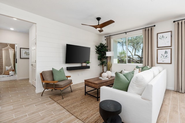 living area featuring recessed lighting, baseboards, ceiling fan, and wood tiled floor