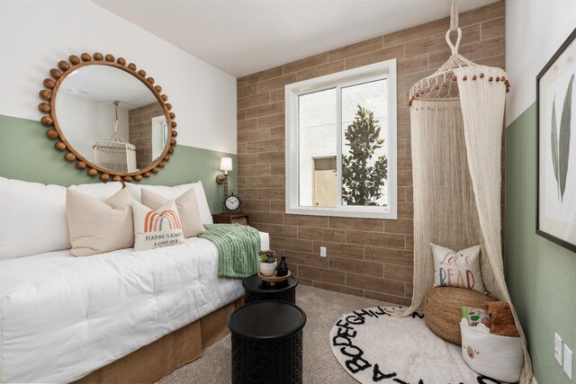 bedroom featuring tile walls