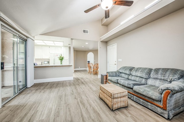 living room with ceiling fan, high vaulted ceiling, a healthy amount of sunlight, and light wood-type flooring