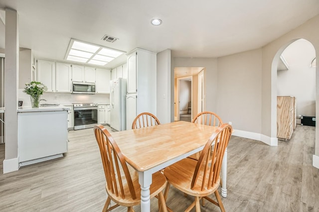 dining area with light hardwood / wood-style floors