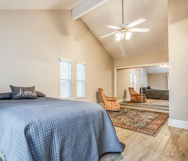 bedroom with beam ceiling, ceiling fan, high vaulted ceiling, and hardwood / wood-style flooring