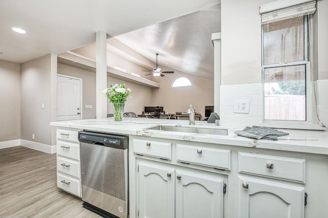 kitchen with stainless steel dishwasher, vaulted ceiling, ceiling fan, sink, and light hardwood / wood-style floors