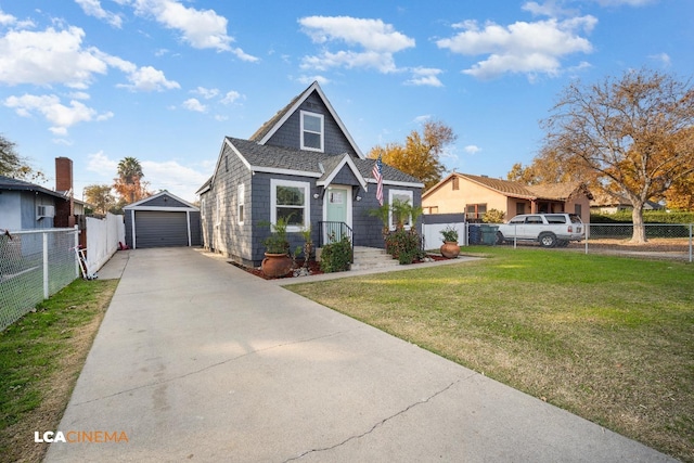 bungalow-style house with an outbuilding, a garage, and a front lawn