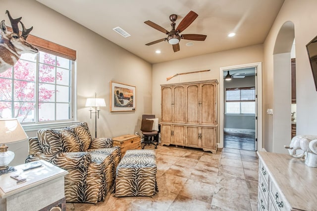 living area featuring ceiling fan