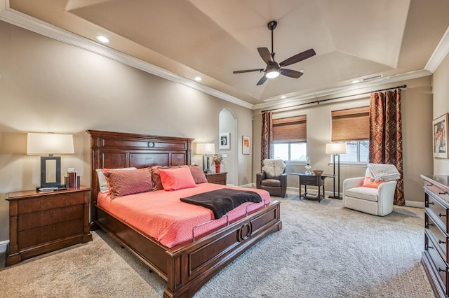 bedroom with a tray ceiling, ceiling fan, light carpet, and ornamental molding