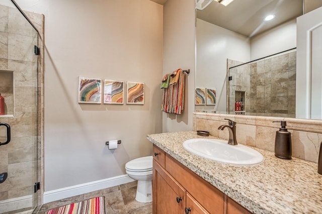 bathroom with toilet, vanity, and walk in shower