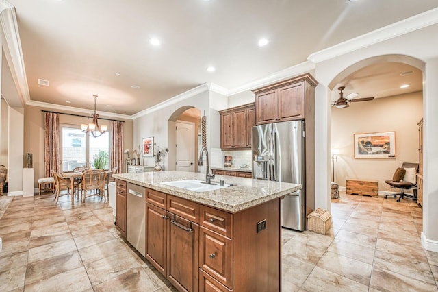 kitchen with ornamental molding, a center island with sink, stainless steel appliances, and sink