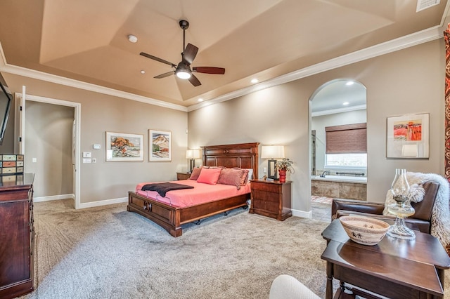 carpeted bedroom with a tray ceiling, ceiling fan, and crown molding