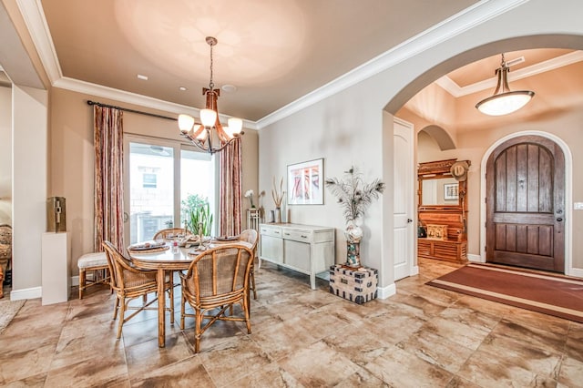 dining area featuring ornamental molding and an inviting chandelier