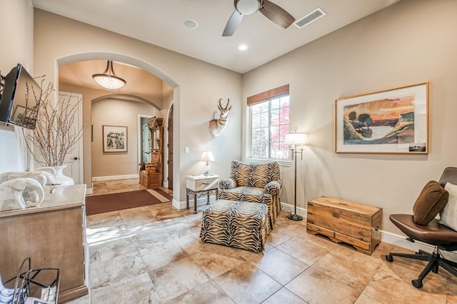 interior space with ceiling fan