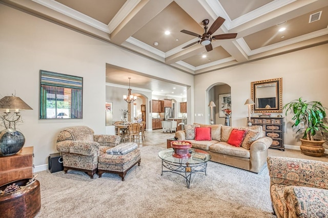 living room featuring carpet flooring, beamed ceiling, ceiling fan with notable chandelier, and ornamental molding