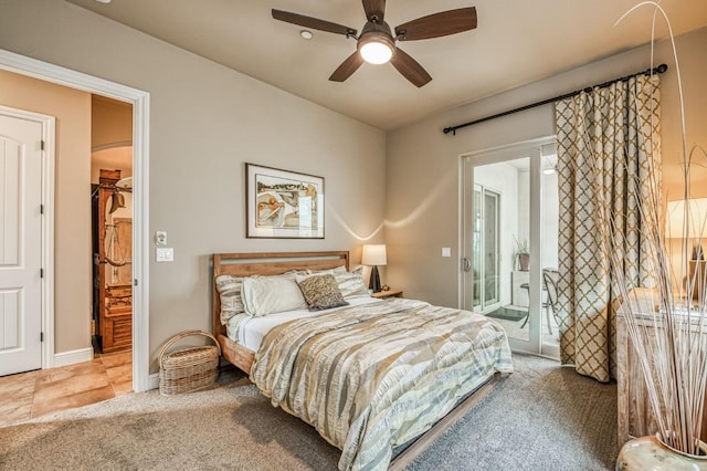 carpeted bedroom featuring access to outside, a walk in closet, ceiling fan, and a closet