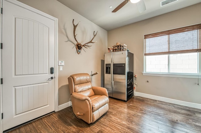 sitting room featuring hardwood / wood-style floors and ceiling fan