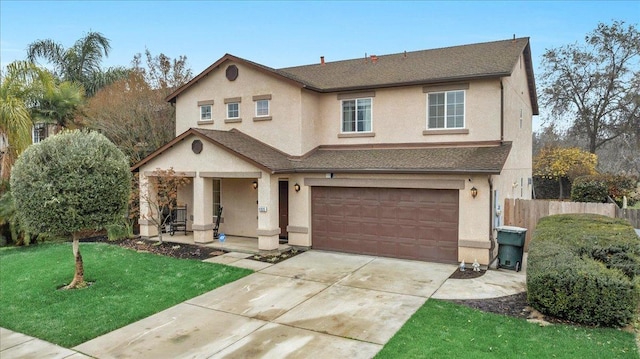 front facade featuring a garage and a front lawn