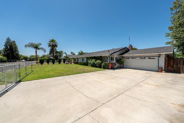 single story home featuring a garage and a front lawn